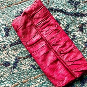 Hot pink real leather clutch with magnetic closure.